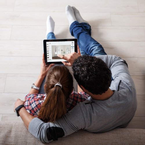 Couple with iPad Riemer Floors